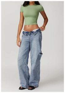 Detail of light green slim fit yoga t-shirt paired with ripped wide leg blue jeans