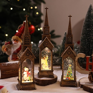 Close-up of three bronze church-style Christmas water lanterns with Santa and Angel scenes