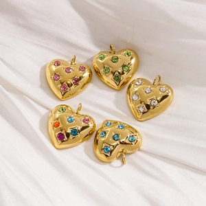 14K gold plated heart pendants with colorful rhinestones on white silk fabric background
