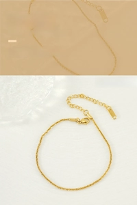 Detailed close-up of a sparkling gold-plated stainless steel anklet with lobster clasp