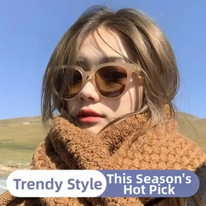 Chic oval sunglasses with light brown frames paired with a thick brown knitted scarf