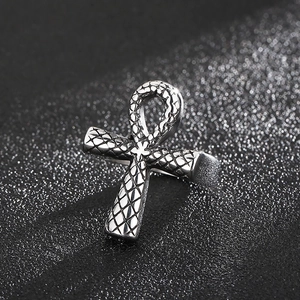 Macro shot of silver Ankh cross ring with detailed scale texture and vintage punk finish
