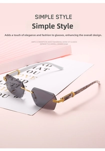 Macro view of rimless geometric grey sunglasses with gold bridge and luxury C-decor