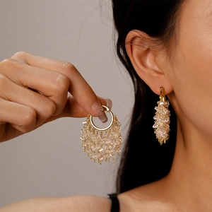 18k gold plated hoop earrings with star crystals and tassel beads in a stylish dangle design