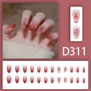 Mid-length coffin press-on nails with pink blush gradient, bows, and heart gems D311