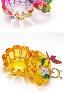 Detailed macro view of rainbow and yellow pumpkin glass jars with golden flower lids