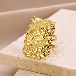 Macro detail of golden irregular lava texture ring with dotted lines on stone base