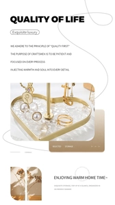 Golden heart-shaped jewelry stand with white ripple base holding rings and necklaces