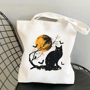 Sac fourre-tout Halloween en toile avec chat noir et citrouilles sur une chaise