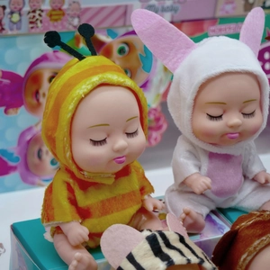 Close-up of 5-inch sleeping baby dolls in plush bee and rabbit animal costumes