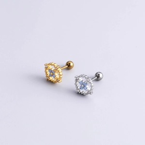 Close-up of gold and silver square stud earrings with blue flowers and screw-back