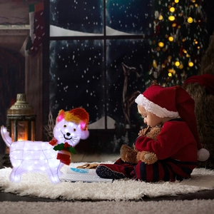 Toddler next to a light-up white Dachshund Christmas figure with hat and scarf