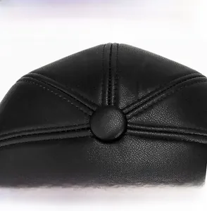 Macro shot of faux leather hat top showing detailed stitching and lychee grain texture