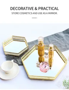 Detailed close-up of golden hexagonal mirrored tray with hollow metal frame and glass base