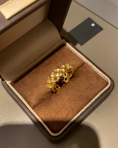 Macro view of gold-plated woven hollow ring with zircon inlay in a velvet jewelry box