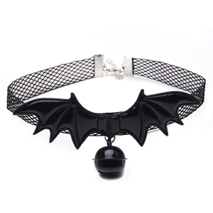 Detail of gothic black lace choker with PU bat wings and metal bell on white background