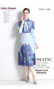 Detail of blue hydrangea print pleated skirt with elegant bow-tie neck design