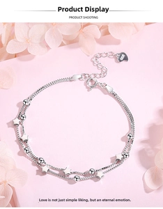 Close-up of S925 sterling silver star charm bracelet with double-layer box chain