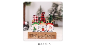 Close-up of three wooden Christmas gnomes on a base with Home Sweet Gnome text