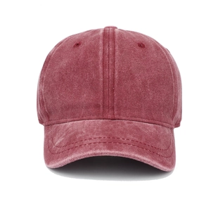 Detail of dark red washed cotton baseball cap showing vintage texture and stitching