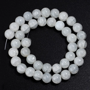 Close-up of white glass beads with ice crackle texture for DIY jewelry making