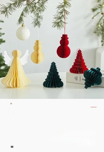 Detail of paper honeycomb Christmas tree and snowman ornaments for holiday window display