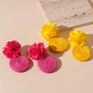 Bohemian floral fabric and woven raffia drop earrings in vibrant pink and yellow colors