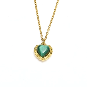Macro detail of French retro heart necklace with green cat-eye stone and 18k gold plating