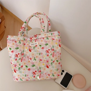 Detailed top view of a quilted floral tote bag with a simple wish label and soft cotton texture