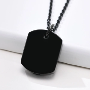 Close-up of a minimalist black stainless steel rectangular bar urn pendant on a necklace