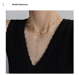 Elegant 18k gold plated titanium Y-shaped necklace with small white pearls on a model