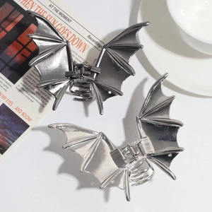 Close-up of silver bat wing metal hair claw clips showing polished metallic texture