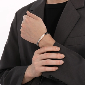 Close-up of tricolor stainless steel watchband bracelet on a male wrist with a suit