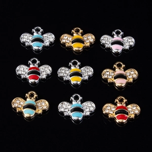 Detailed set of nine crystal-encrusted bee pendants in gold and silver with colorful enamel