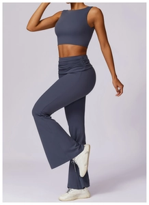 Detail view of high-waist yoga pants with ruched waistband and flared leg in slate blue