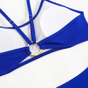 Macro detail of royal blue bikini top with golden O-ring and adjustable straps