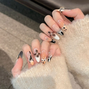 Handmade press-on nails with butterfly motifs, leopard print, and rhinestones