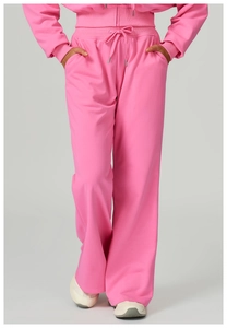 Detail of pink tracksuit featuring high-waist wide-leg pants and drawstring waistband