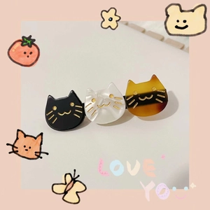 Three-piece acetate cat-shaped hair clip in black, white and tortoiseshell pattern