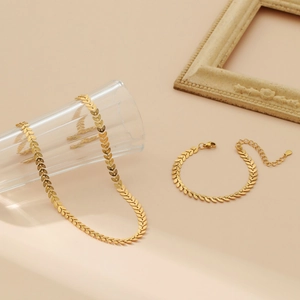 Minimalist 18k gold wheat ear jewelry set with necklace and bracelet by glass