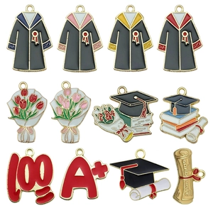 Detailed flat lay of colorful enamel graduation charms including caps and certificates