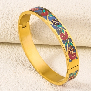 Detailed macro view of 18K gold plated bangle with colorful enamel floral patterns