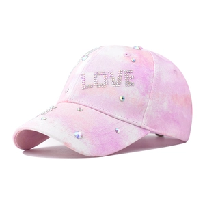 Pink tie-dye baseball cap with sparkling crystal LOVE lettering and rhinestone accents