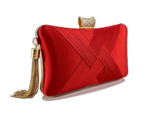 Detail of red satin clutch bag with gold woven texture, crystal clasp and metal fringe