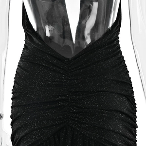 Detail view of black glitter dress with ruched fabric and deep V-back on a mannequin