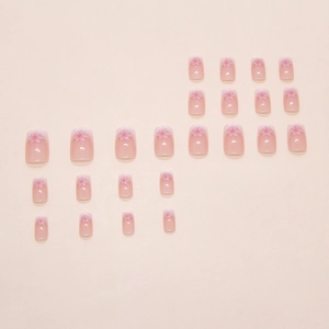 Pink gradient press-on nails with cherry blossom patterns and small square shape