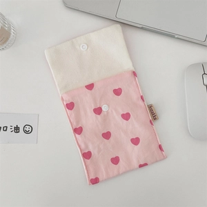 Close-up of pink heart pattern canvas tote bag with plastic snap button and fabric tag
