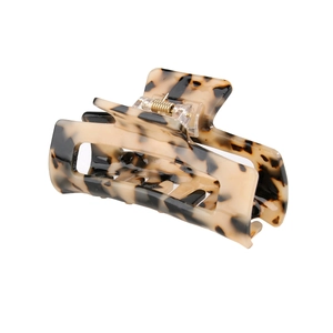 Detail shot of the 8.2cm rectangular tortoise shell hair claw with golden spring