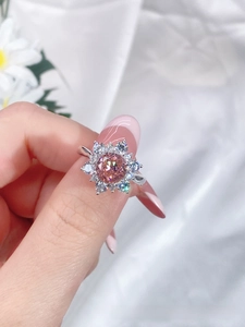 Macro shot of S925 sterling silver petal ring with pink sapphire main stone and side diamonds