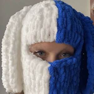 Detailed knit texture of white and blue balaclava with long rabbit ears and soft yarn
